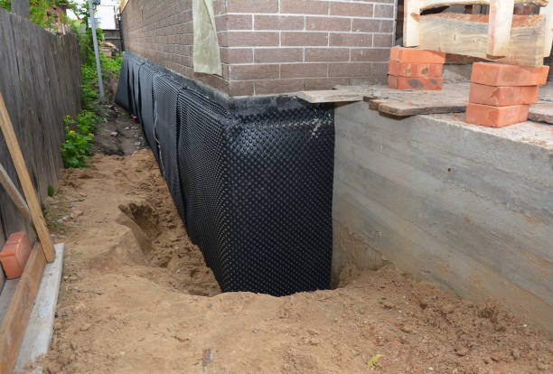 SJ Waterproofing Pros technician performing targeted Wet Basement Repair assessment in Covington, GA